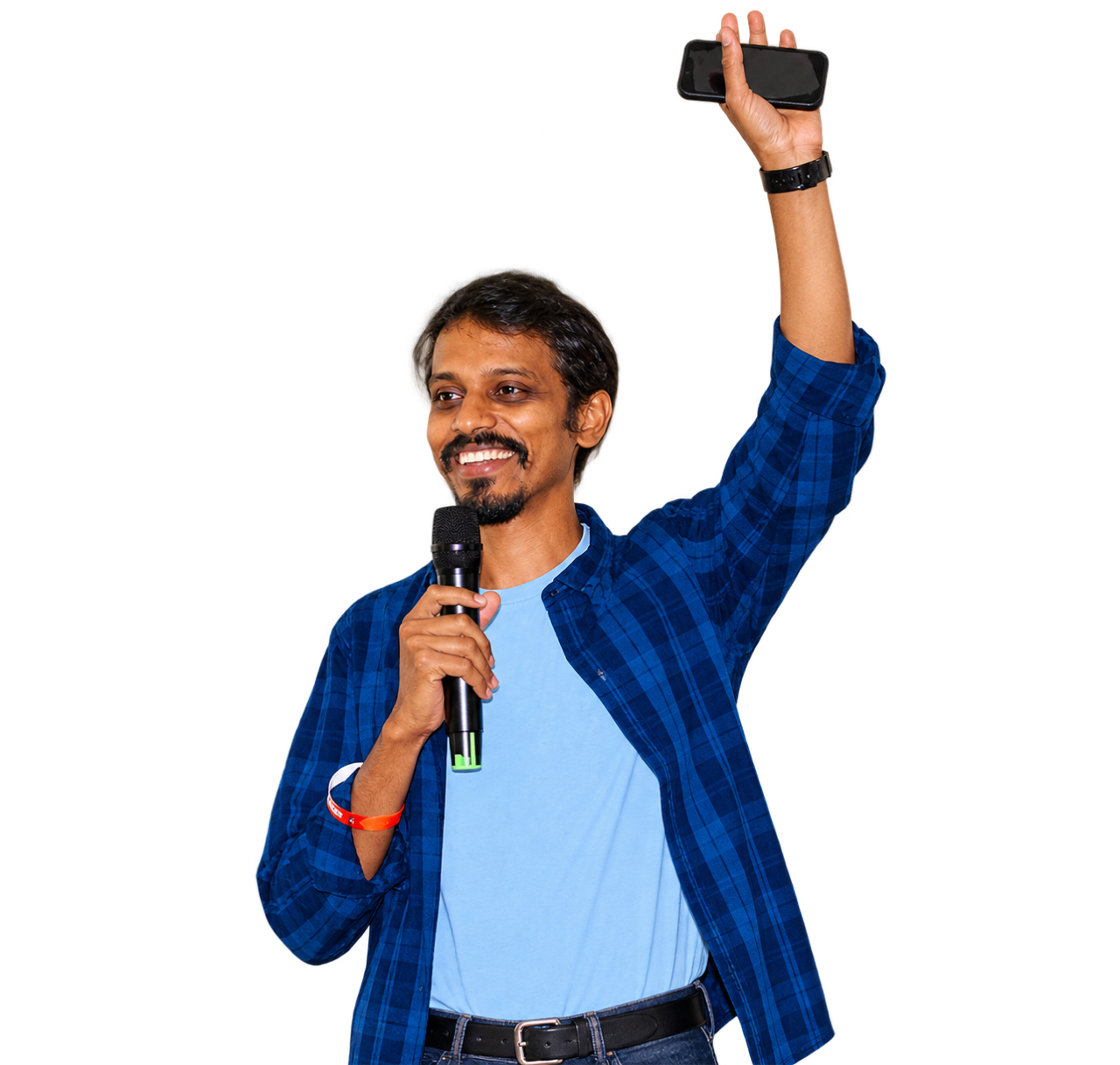 Raja speaking on stage, holding a microphone and raising a phone